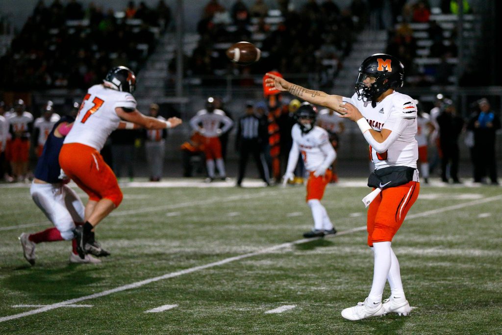 Monroe quarterback Blake Springer dumps off a screen against Arlington on Friday, Oct. 27, 2023, at Arlington High School in Arlington, Washington. (Ryan Berry / The Herald)