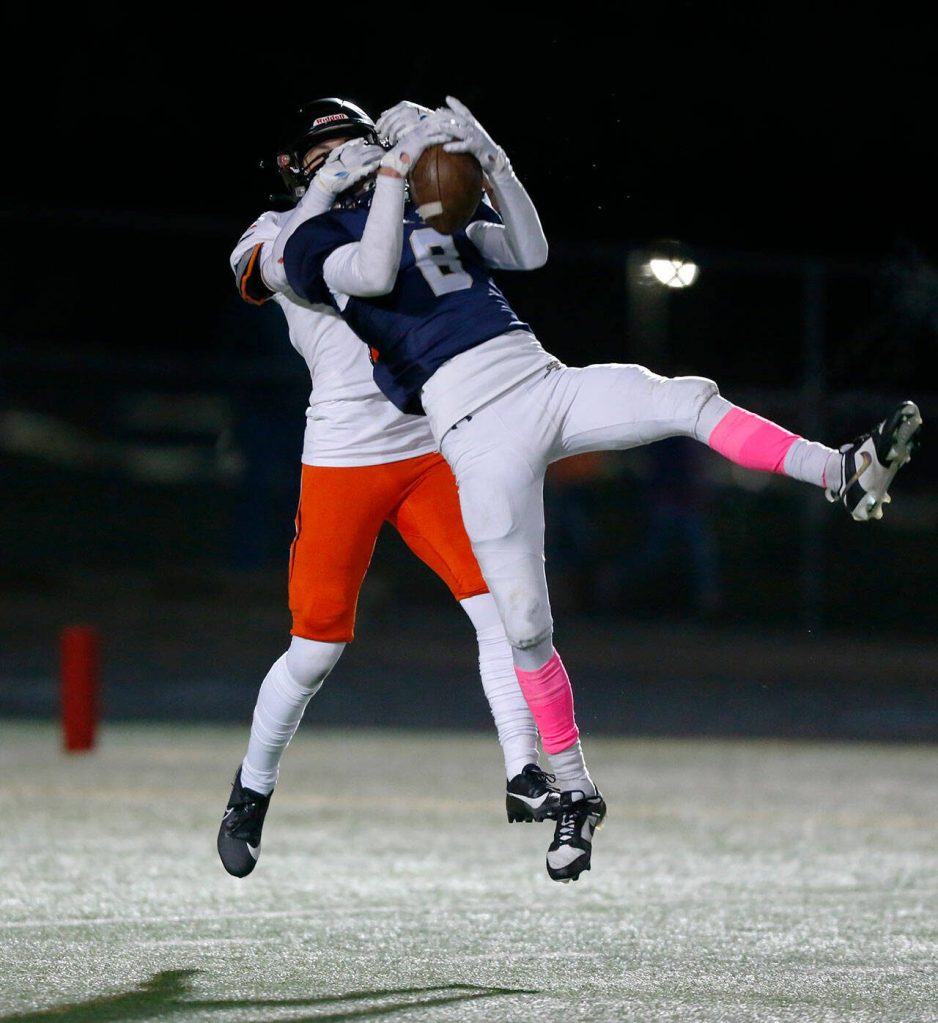 Arlingtons Kaid Hunter picks off a long throw by Monroe on Friday, Oct. 27, 2023, at Arlington High School in Arlington, Washington. (Ryan Berry / The Herald)