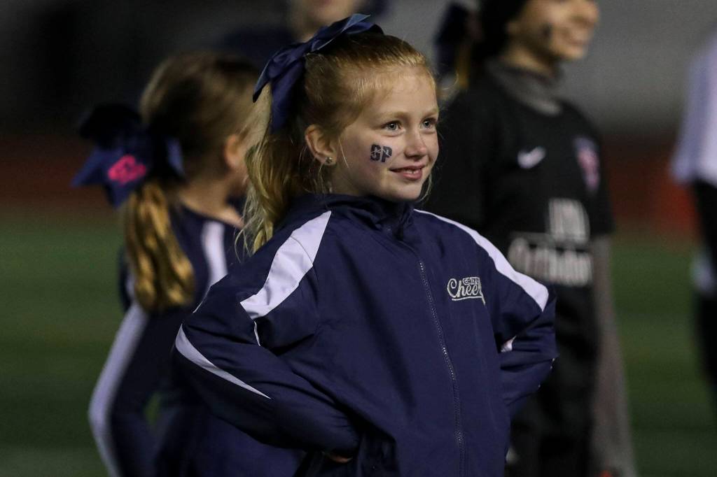 A Glacier Peak cheerleader smiles during a game between Glacier Peak and Lake Stevens at Veterans Memorial Stadium in Snohomish, Washington on Friday, Oct. 27, 2023. Lake Stevens won, 42-7. (Annie Barker / The Herald)