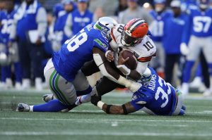 Cleveland Browns quarterback PJ Walker (10) is tackled by Seattle Seahawks linebacker Derick Hall (58) and safety Jamal Adams (33) in the second half of Sundays game in Seattle. (AP Photo/Lindsey Wasson)