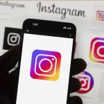 The Instagram logo is seen on a cell phone in Boston. Meta, the parent company of Facebook and Instagram is being sued by the attorneys general for 40 states over features that allegedly harm children and youths. (Michael Dwyer/ Associated Press File)
