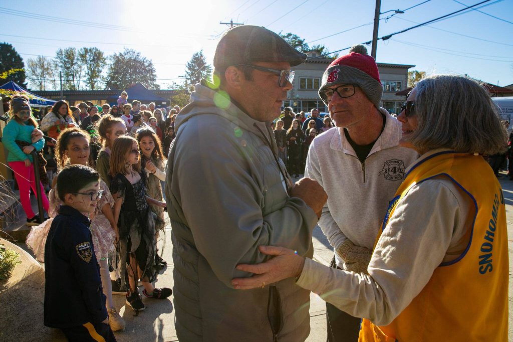Judges conspire to choose the winner of the youth zombie-off during the 10th annual Snohomish Zombie Walk on Saturday, Oct. 28, 2023, in downtown Snohomish, Washington. (Ryan Berry / The Herald)