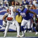 New York Giants defensive end Leonard Williams (99) sacks Washington Commanders quarterback Sam Howell (14) during a game Sunday in East Rutherford, N.J. (AP Photo/Adam Hunger)