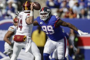 New York Giants defensive end Leonard Williams (99) sacks Washington Commanders quarterback Sam Howell (14) during the first quarter an NFL football game, Sunday, Oct. 22, 2023, in East Rutherford, N.J. (AP Photo/Adam Hunger)