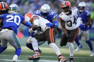 Seattle Seahawks linebacker Jordyn Brooks (56) tackles Cleveland Browns quarterback PJ Walker (10) as running back Jerome Ford (34) looks on during the second half of an NFL football game Sunday, Oct. 29, 2023, in Seattle. The Seahawks won 24-20. (AP Photo/Lindsey Wasson)