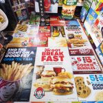Fast-food signs cover the floor of the Snackin Shack. (Olivia Vanni / The Herald)