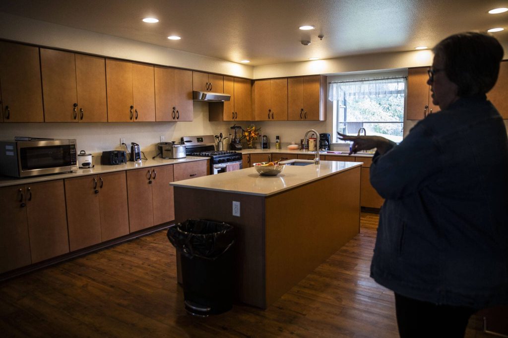 Suzanne Peterson, director of the family shelter for Everett Gospel Mission, talks about the food cupboards available to residents on Tuesday, Oct. 3, 2023 in Everett, Washington. (Olivia Vanni / The Herald)
