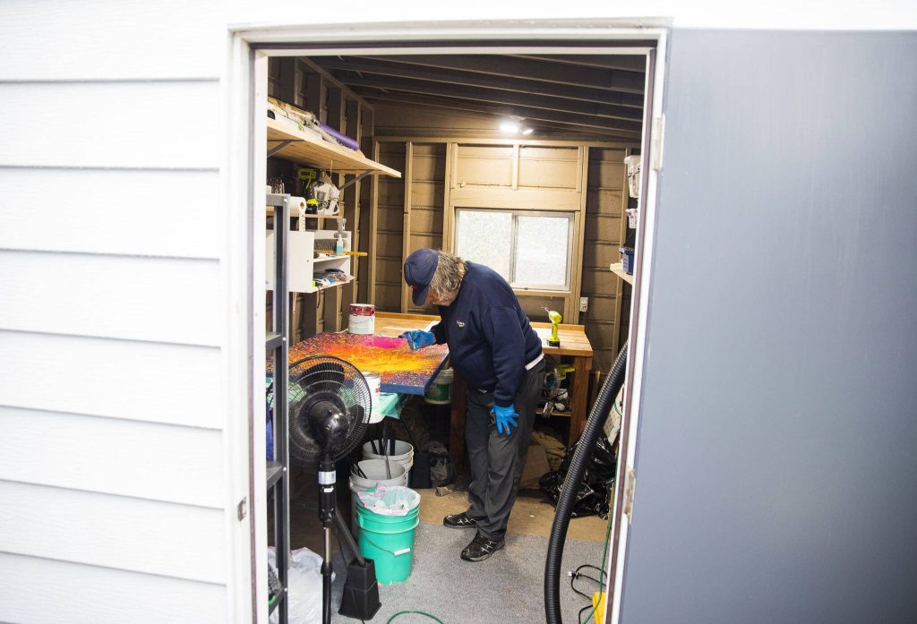Sam Taylor, 73, in one of his painting spaces in his home in Everett. (Olivia Vanni / The Herald)