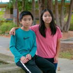 Siblings Qingyun, left, and Ruoyun Li, 12 and 13, respectively, are together on campus at Everett Community College on Thursday, Oct. 19, 2023, in Everett, Washington. The two are taking a full course load at the community college this semester. (Ryan Berry / The Herald)