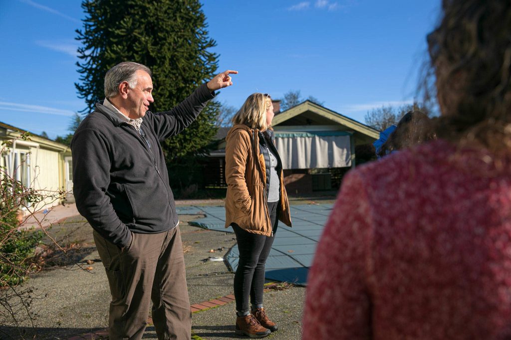 John Roth, whose family owned the property since 1974, points out over the farmland behind his former home at a Sofie Road property purchased by the county for Skykomish River floodplain restoration on Thursday, Nov. 16, 2023, in Monroe, Washington. (Ryan Berry / The Herald)