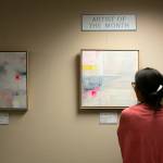 Store manager Rika Rafael looks over guest art at East West Books & Gifts on Friday, Oct. 27, 2023, in Edmonds, Washington. The store plans to rotate through guest artists every three months. (Ryan Berry / The Herald)