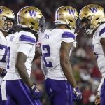 Washington wide receiver Ja'Lynn Polk (2) is congratulated by quarterback Michael Penix Jr., right, after scoring against Stanford during the second half of an NCAA college football game in Stanford, Calif., Saturday, Oct. 28, 2023. (AP Photo/Jeff Chiu)