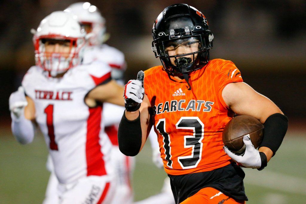 Monroe receiver Aaron Clifton checks for defenders while taking a long reception for a touchdown against Mountlake Terrace on Sept. 29 in Monroe. (Ryan Berry / The Herald)
