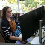 A crisis counselor with Volunteers of America Western Washington talks with a caller in July 2022, at the VOA Behavioral Health Crisis Call Center in Everett. (Ryan Berry / The Herald file photo)