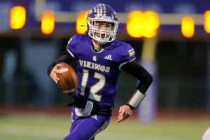 Lake Stevens’ Kolton Matson scrambles for a solid gain during the 4A semifinal against Graham-Kapowsin on Saturday, Nov. 26, 2022, at Lake Stevens High School in Lake Stevens, Washington. (Ryan Berry / The Herald)