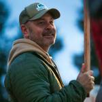 Snohomish County Sheriff Adam Fortney waves signs with supporters along Highway 9 on Monday, Nov. 6, 2023, in Arlington, Washington. (Ryan Berry / The Herald)