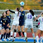 Everett senior defender Lanie Thompson, center, tries to head away a corner kick from in front of her teams goal during a district playoff matchup against Oak Harbor on Thursday, Nov. 2, 2023, at Shoreline Stadium in Shoreline, Washington. (Ryan Berry / The Herald)