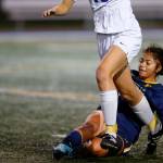 Everett midfielder Genesis Molina Escobar tackles the ball away from an opponent during a district playoff matchup against Oak Harbor on Thursday, Nov. 2, 2023, at Shoreline Stadium in Shoreline, Washington. (Ryan Berry / The Herald)