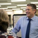 Garth Fell, incumbent Snohomish County Auditor, cracks a smile as the first results of the 2023 election appear on a screen at the elections office in Administrative Building West on Tuesday, Nov. 7, 2023, in downtown Everett, Washington. Fell led by nearly 20% after initial results. (Ryan Berry / The Herald)