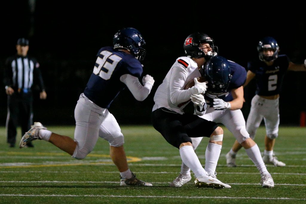Arlington linebacker Kobi Spady lays out Ballards Adam Tripp during a playoff matchup Friday, Nov. 3, 2023, at Arlington High School in Arlington, Washington. (Ryan Berry / The Herald)