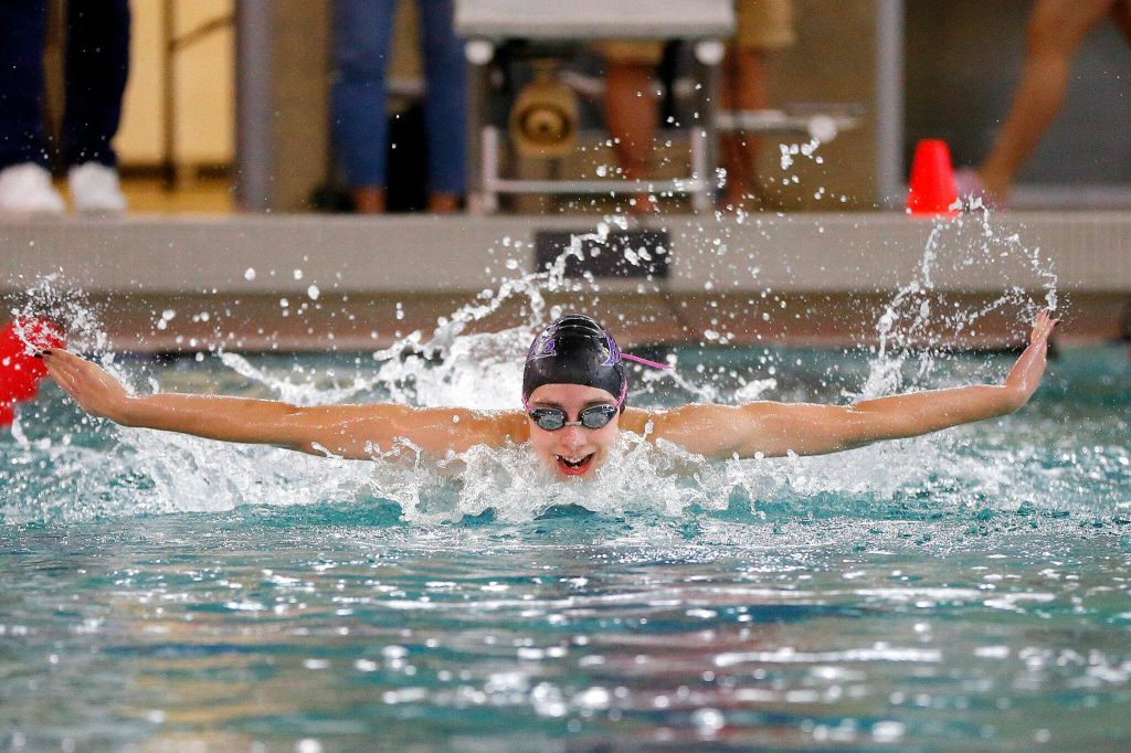 Kamiak senior Claire Smith swims her way to victory in the 100 yard butterfly during the Wesco 4A District 1 Girls Swim and Dive Finals on Saturday, Nov. 4, 2023, at the Snohomish Aquatic Center in Snohomish, Washington. (Ryan Berry / The Herald)
