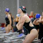 Snohomish senior Mary Clarke throws water on herself while prepping for the 100 yard freestyle during the Wesco 3A Division 1 Girls Swim and Dive Finals on Saturday, Nov. 4, 2023, at the Snohomish Aquatic Center in Snohomish, Washington. (Ryan Berry / The Herald)