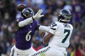 Seattle Seahawks quarterback Geno Smith (7) passes over Baltimore Ravens linebacker Patrick Queen (6) during the second half of Sundays game in Baltimore. (AP Photo/Alex Brandon)