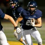 Arlington running back Caleb Reed takes a handoff against Ballard during a playoff matchup Friday in Arlington. The Eagles are seeded third in Class 3A. (Ryan Berry / The Herald)