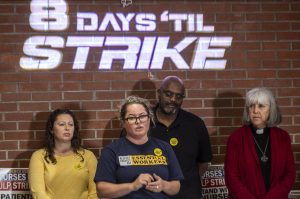 UFCW 3000 President Faye Guenther, second from left, speaks during a press confrence for the Providence nurses who gave a 10-day strike notice two days ago at the Everett Labor Temple in Everett, Washington on Monday, Nov. 6, 2023. (Annie Barker / The Herald)