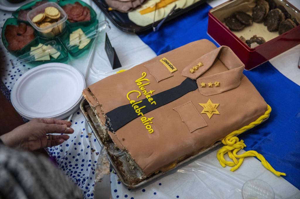 A cake is cut at Susanna Johnson’s election watch party at 230 Ave B. in Snohomish, Washington on Tuesday, Nov. 7, 2023. (Annie Barker / The Herald)