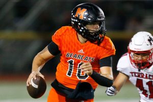 Monroe’s Blake Springer rolls out of the pocket before firing downfield against Mountlake Terrace on Friday, Sept. 29, 2023, at Monroe High School in Monroe, Washington. (Ryan Berry / The Herald)