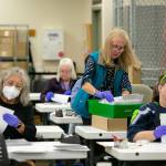 Election workers remove ballots from their envelopes before sending them to be counted at the Snohomish County Auditor’s office on Friday, Nov. 3, 2023, in downtown Everett, Washington. (Ryan Berry / The Herald)