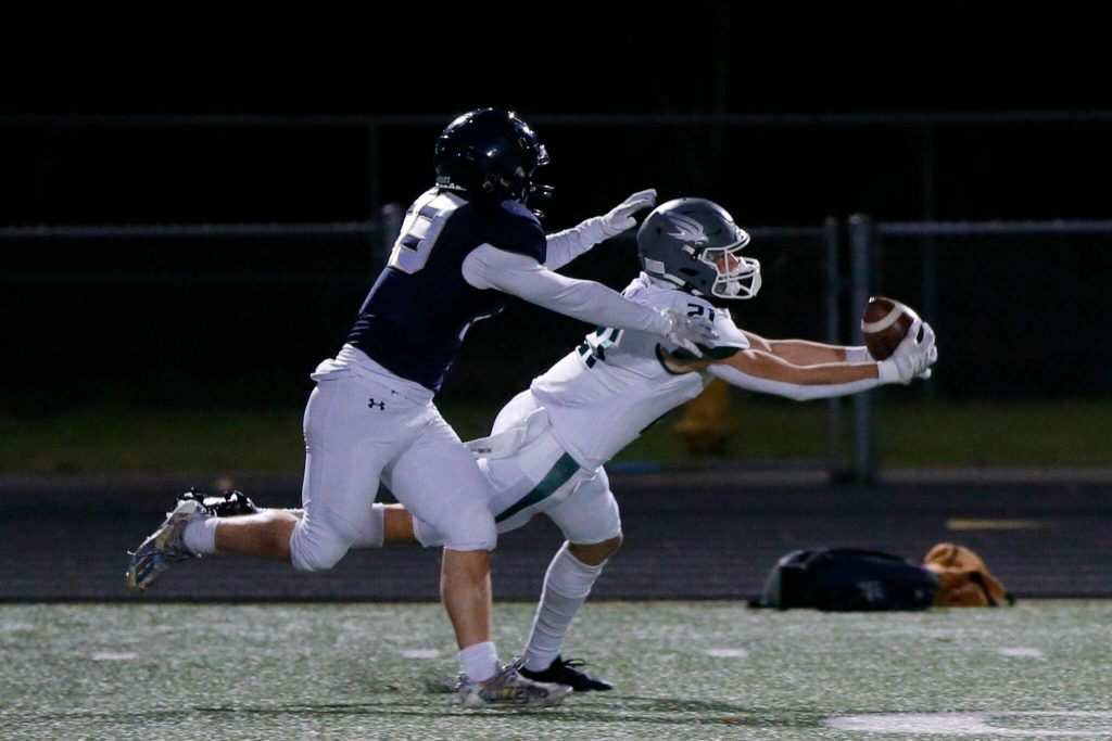 Ridgelines Lincoln Duggan comes down with a long pass against Arlington during a playoff matchup Friday, Nov. 10, 2023, at Arlington High School in Arlington, Washington. (Ryan Berry / The Herald)