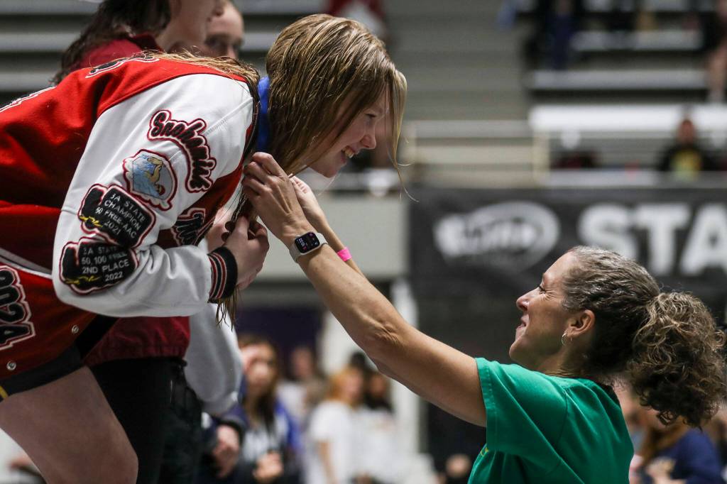 Snohomishs Mary Clarke recieves a medal for winning the 100-yard freestyle during the Class 3A girls state swim and dive championships Saturday at King County Aquatic Center in Federal Way. (Annie Barker / The Herald)