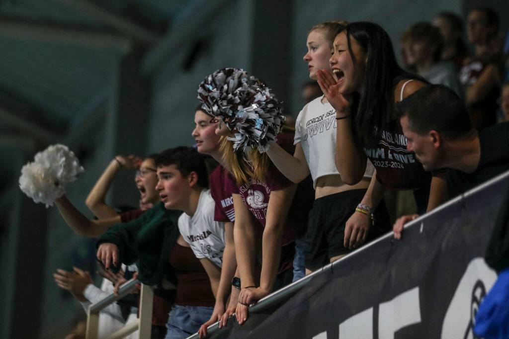 Fans cheer during the 3A girls state swim and dive championships at King County Aquatic Center in Federal Way, Washington on Saturday, Nov. 11, 2023. (Annie Barker / The Herald)