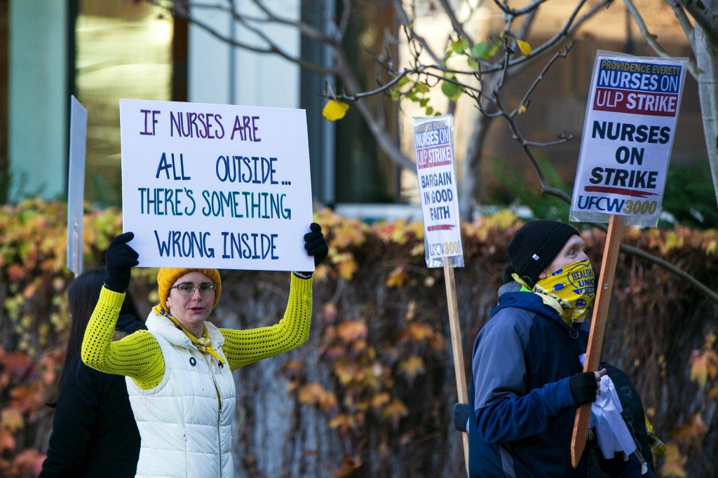 Providence nurses picket in front of the hospital during the first day of their planned five-day strike Tuesday, Nov. 14, 2023, at Providence Regional Medical Center in Everett, Washington. (Ryan Berry / The Herald)