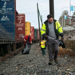 Evan Reed heads back to his vehicle after a few hours of picking up litter along Marine View on Sunday, Nov. 19, 2023, in Everett, Washington. Reed started out cleaning up trash on his own, but has gained a few volunteers via the website Reddit. (Ryan Berry / The Herald)
