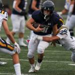 Arlingtons Stevie Balderas (81) is tackled during a Class 3A state quarterfinal game against Bellevue on Saturday in Arlington. (Annie Barker / The Herald)