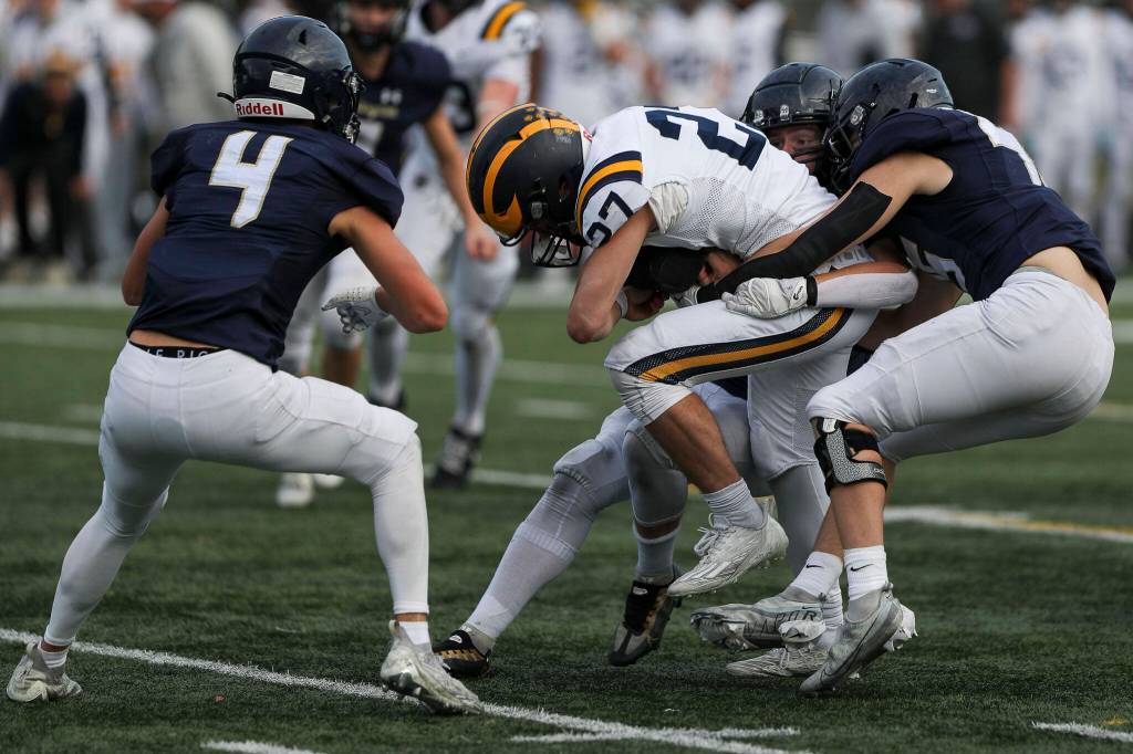 Bellevues Blake Teets (27) is tackled during the Arlington and Bellevue Class 3A state quarterfinal game at Arlington High School in Arlington, Washington on Saturday, Nov. 18, 2023. Arlington lost, 35-17. (Annie Barker / The Herald)