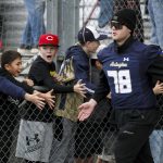 Arlington players take the field during the Arlington and Bellevue Class 3A state quarterfinal game at Arlington High School in Arlington, Washington on Saturday, Nov. 18, 2023. Arlington lost, 35-17. (Annie Barker / The Herald)