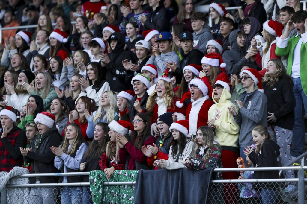 Fans cheer during the Arlington and Bellevue Class 3A state quarterfinal game at Arlington High School in Arlington, Washington on Saturday, Nov. 18, 2023. Arlington lost, 35-17. (Annie Barker / The Herald)