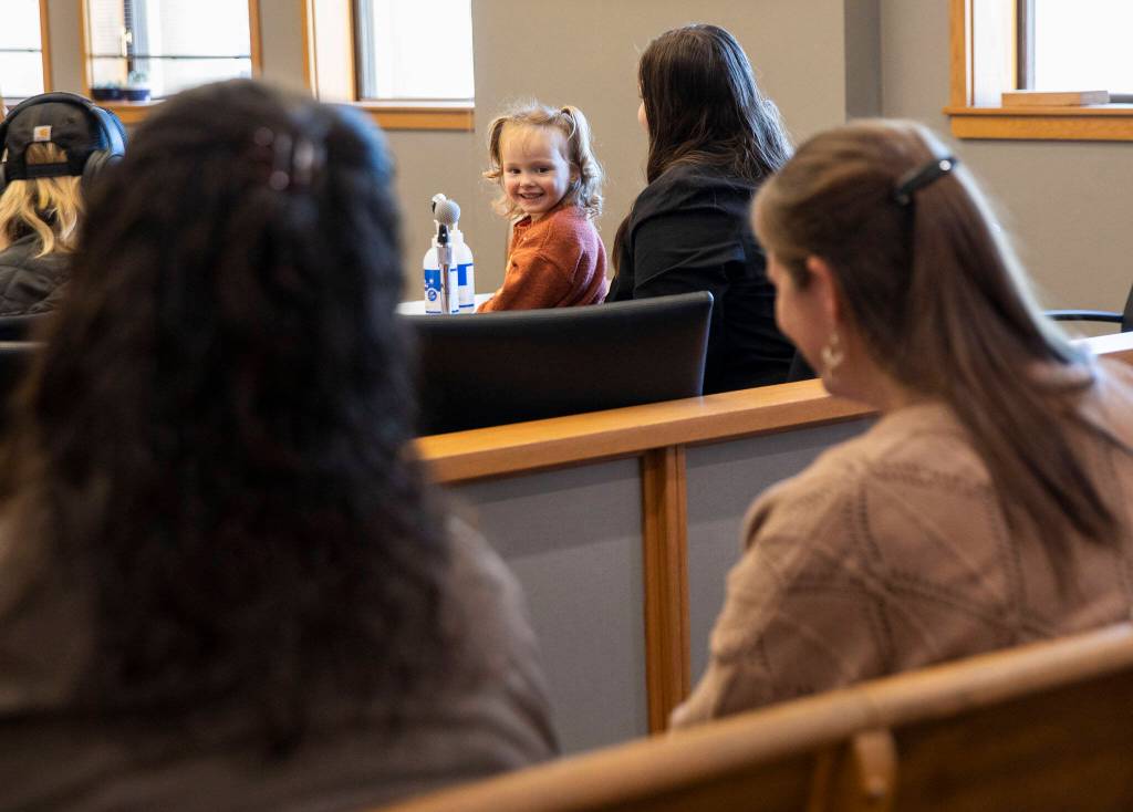 Mayzie Foster turns around and smiles at her grandparents after her adoption during National Adoption Day at the Snohomish County Courthouse on Friday, Nov. 17, 2023 in Everett, Washington. (Olivia Vanni / The Herald)
