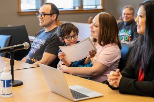 Valentino Warr, 5, smiles while holding his certificate of adoption during National Adoption Day at the Snohomish County Courthouse on Friday, Nov. 17, 2023 in Everett, Washington. (Olivia Vanni / The Herald)
