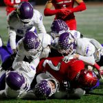 A gang of Lake Stevens defenders stop Xe'Ree Alexander against Kennedy Catholic in the WIAA 4A State Football Championship game Saturday, Dec. 3, 2022, at Mount Tahoma Stadium in Tacoma, Washington. (Ryan Berry / The Herald)