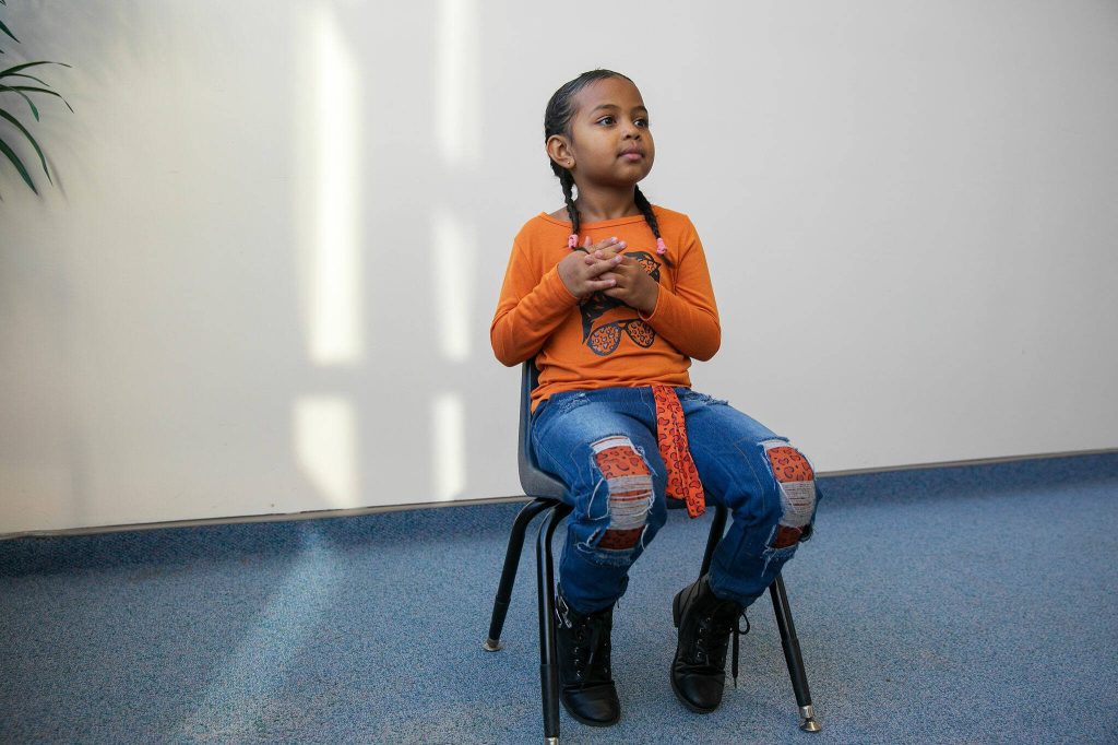 Ridayna listens to a question during an interview with the Herald on Monday, Nov. 20, 2023, at Jackson Elementary School in Everett, Washington. (Ryan Berry / The Herald)