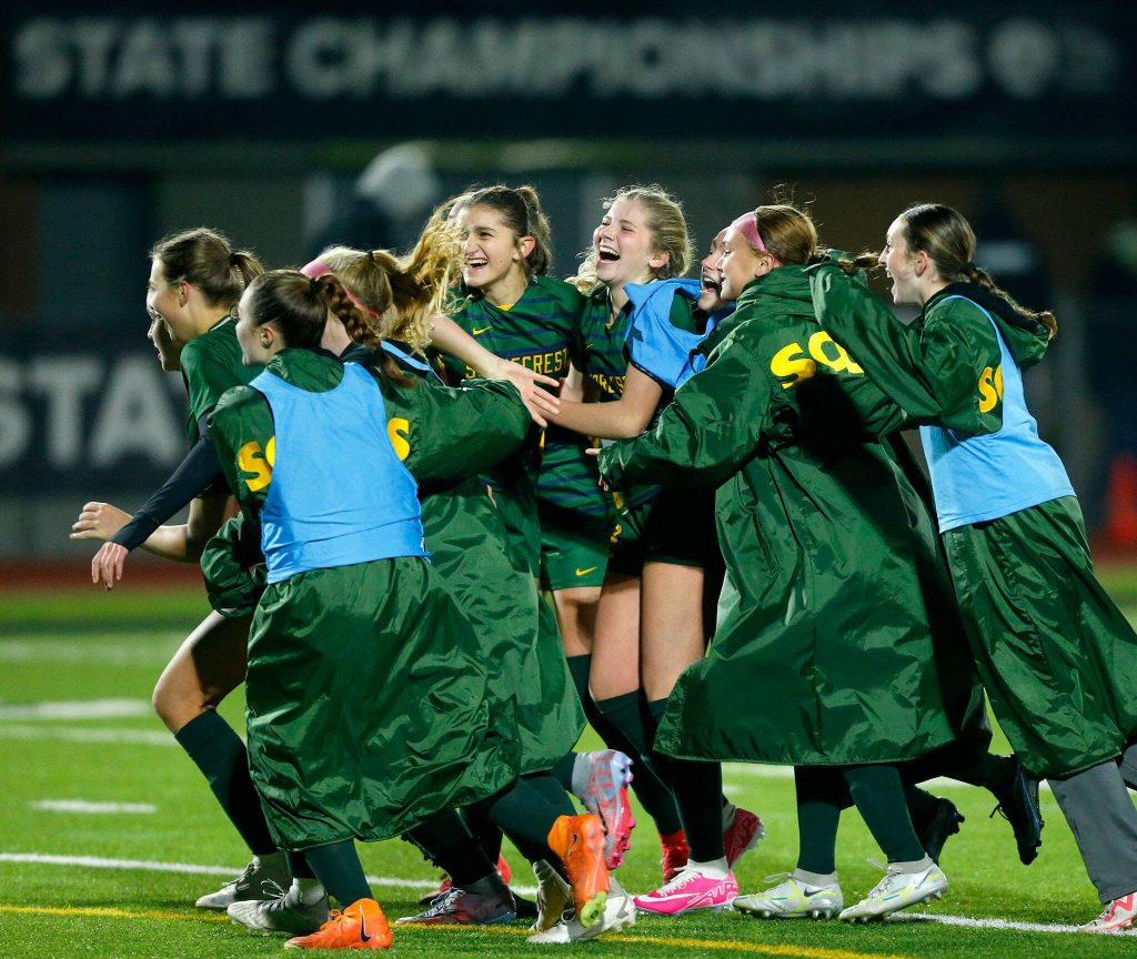 Shorecrest players storm the field after winning over Lakeside during the WIAA 3A Girls Soccer Semifinal on Friday, Nov. 17, 2023, at Carl Sparks Stadium in Puyallup, Washington. (Ryan Berry / The Herald)