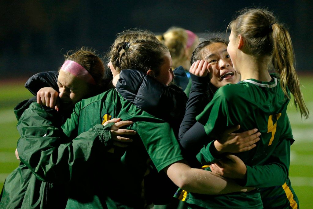 Shorecrest players embrace after a dramatic victory in PKs against Lakeside during the WIAA 3A Girls Soccer Semifinal on Friday, Nov. 17, 2023, at Carl Sparks Stadium in Puyallup, Washington. (Ryan Berry / The Herald)