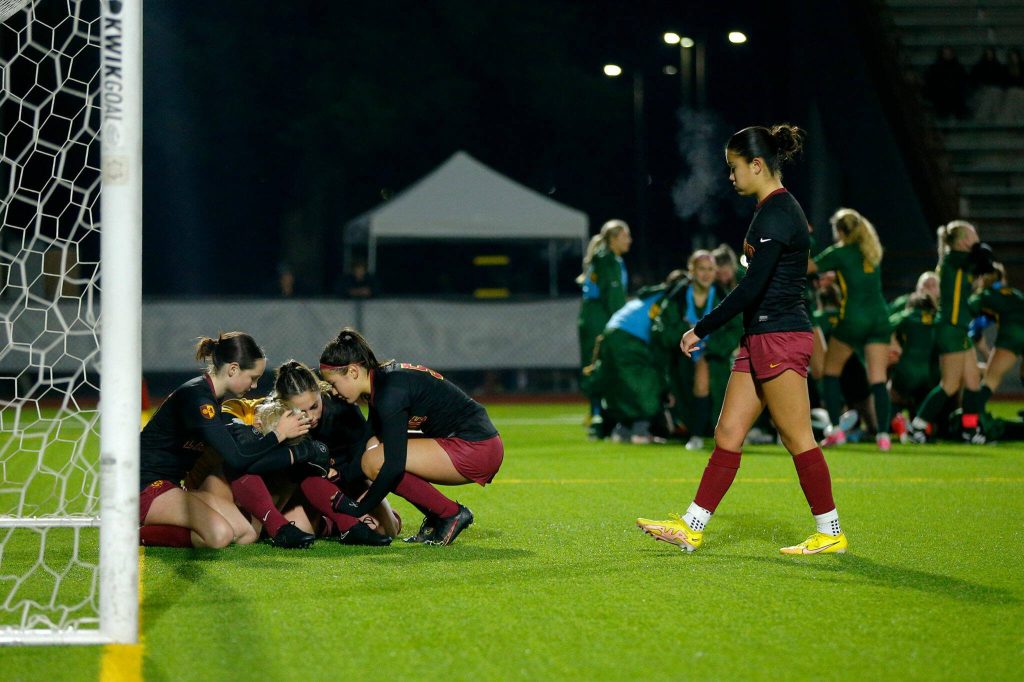 Lakeside players console goaltender Isabel Willems as Shorecrest celebrates their victory during the WIAA 3A Girls Soccer Semifinal on Friday, Nov. 17, 2023, at Carl Sparks Stadium in Puyallup, Washington. (Ryan Berry / The Herald)
