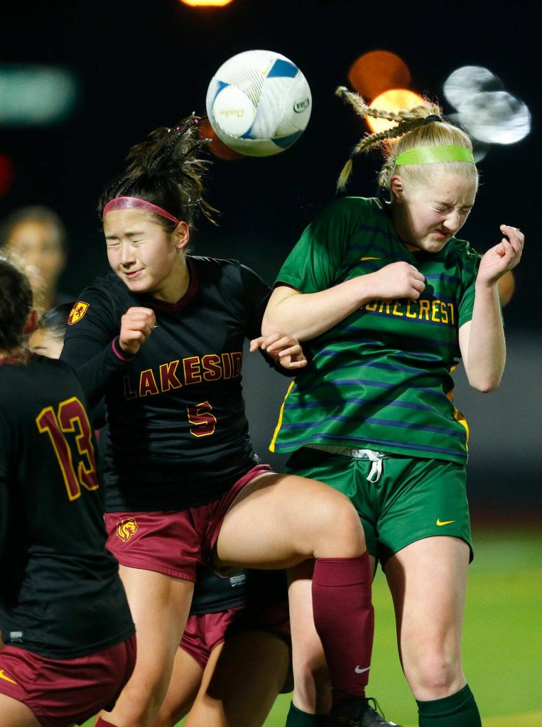 Shorecrest sophomore Kiernan Ledoux and Lakeside’s Ella Carpenter both try to head a 50/50 ball during the WIAA 3A Girls Soccer Semifinal on Friday, Nov. 17, 2023, at Carl Sparks Stadium in Puyallup, Washington. (Ryan Berry / The Herald)