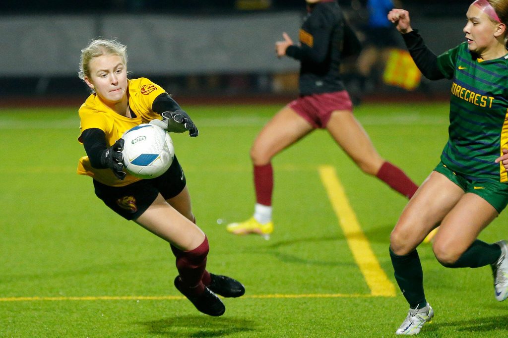 Shorecrest’s Mischa Slimp closes in as Lakeside goalkeeper Isabel Willems makes a diving stop during the WIAA 3A Girls Soccer Semifinal on Friday, Nov. 17, 2023, at Carl Sparks Stadium in Puyallup, Washington. (Ryan Berry / The Herald)